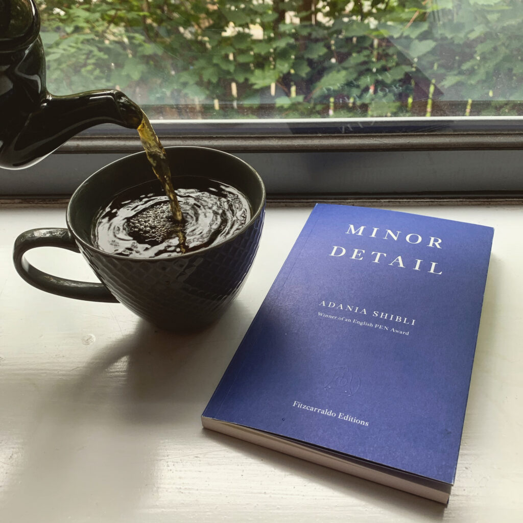 A photo of Minor Detail by Adania Shibli on a windowsill